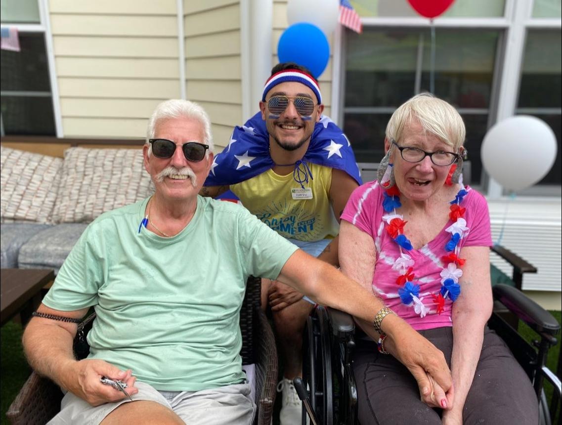Seniors enjoying a Memorial Day gathering with a caregiver